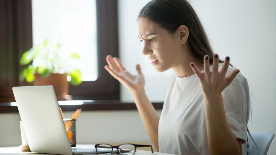 Woman Looking Annoyed in front of a Computer