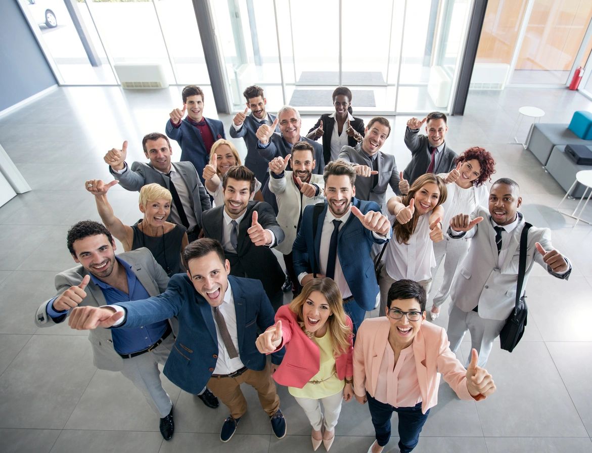 A Group of People in Suits lifting their thumbs up